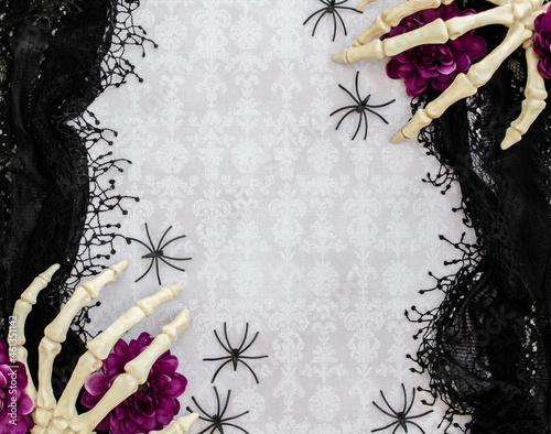 Skeleton hands on a black lacey background, damask and spiders 