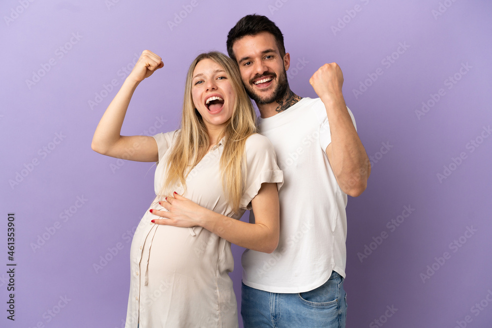 Young couple pregnant and celebration a victory Young couple pregnant and celebration a victory