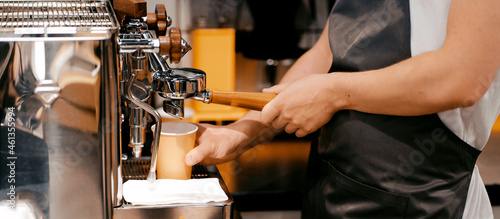 Sells drinks and food in cafes. An employee prepares a latte coffee. An entrepreneur and his restaurant are a small business. A man works in a cafe.