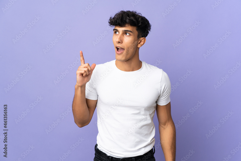 Young Argentinian man isolated on background thinking an idea pointing the finger up Young Argentinian man isolated on background thinking an idea pointing the finger up