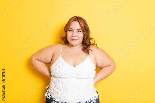 Plus size redhead young woman modeling with smile. overweight model