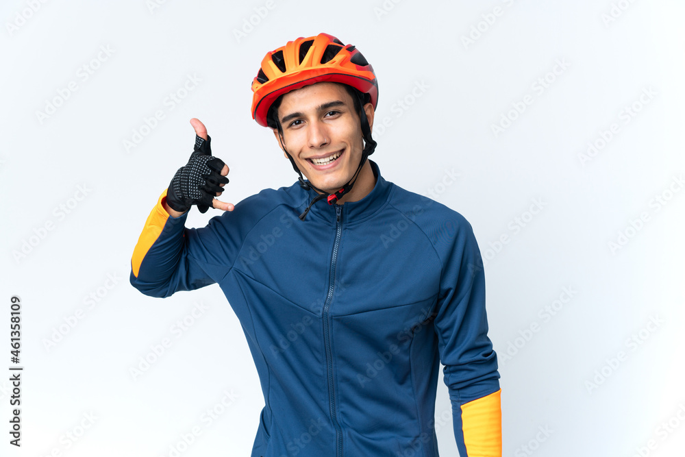 Young cyclist man isolated on background making phone gesture. Call me back sign Young cyclist man isolated on background making phone gesture. Call me back sign