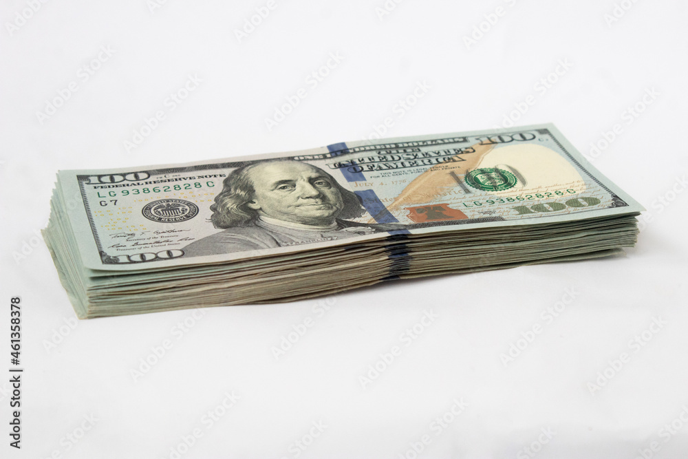 A stack of hundred-dollar bills on a white isolated background. 100 dollar bills A stack of hundred-dollar bills on a white isolated background. 100 dollar bills