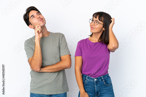 Young couple isolated on isolated white background thinking an idea while scratching head