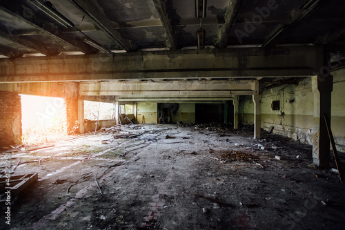 Abandoned large industrial hall with garbage waiting for demolition