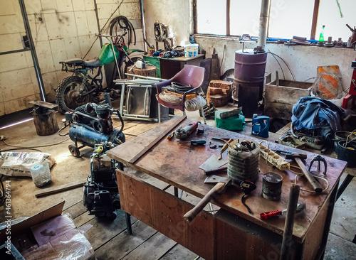 Bild auf Leinwand Workshop scene, interior of an old dirty garage full of stuff