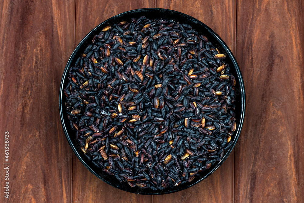 Black venus rice pile isolated on wooden background in Brazil Black venus rice pile isolated on wooden background in Brazil