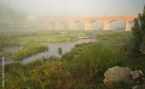 Red brick bridge and mist in Kuldiga, Latvia.