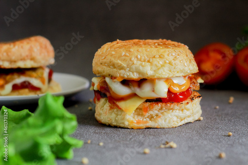 beef burger with tomato sauce and mayonnaise on a dark background