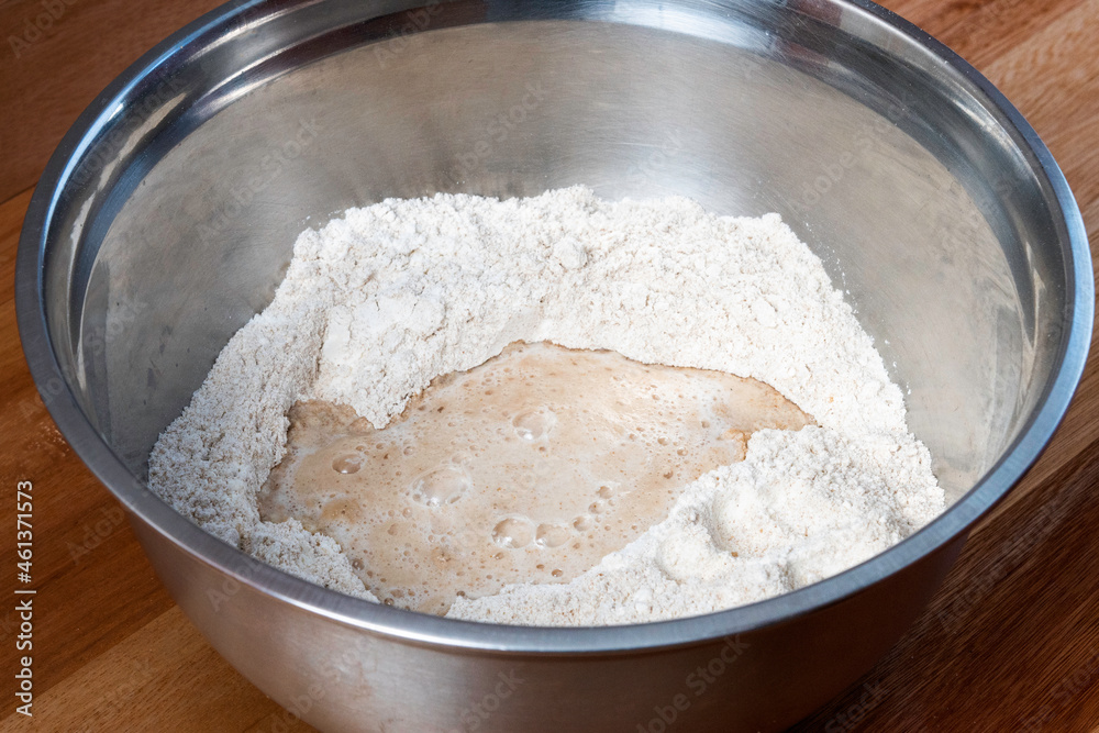 aluminum bowl with flour and fermenting yeast