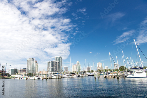 Marina with white yachts under blue sky