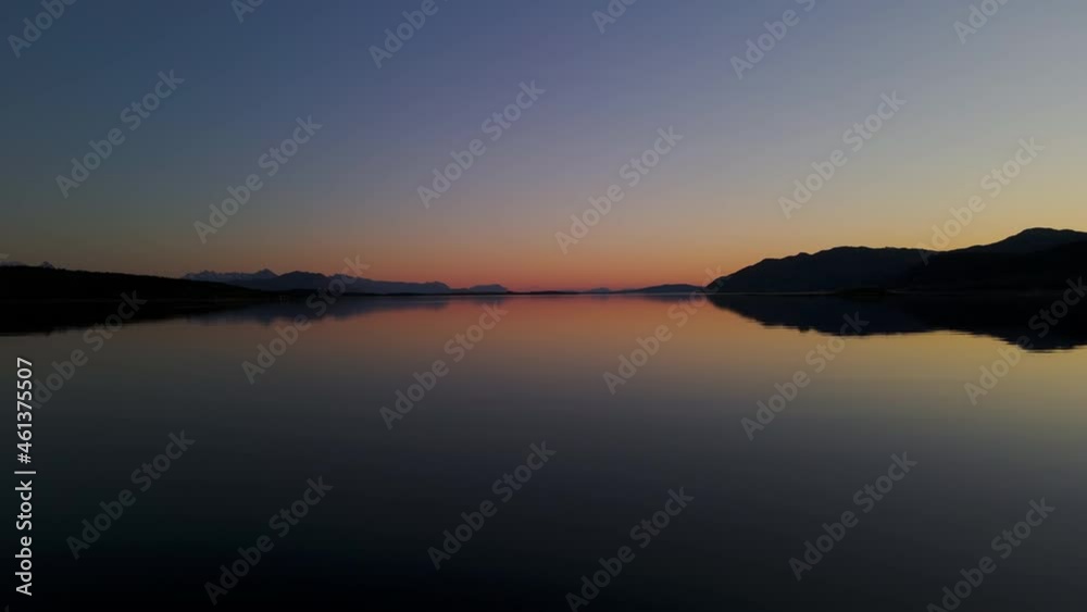 Silhouette Of Senja Island With Mirror Reflection At Sunset In Norway. - wide shot Silhouette Of Senja Island With Mirror Reflection At Sunset In Norway. - wide shot