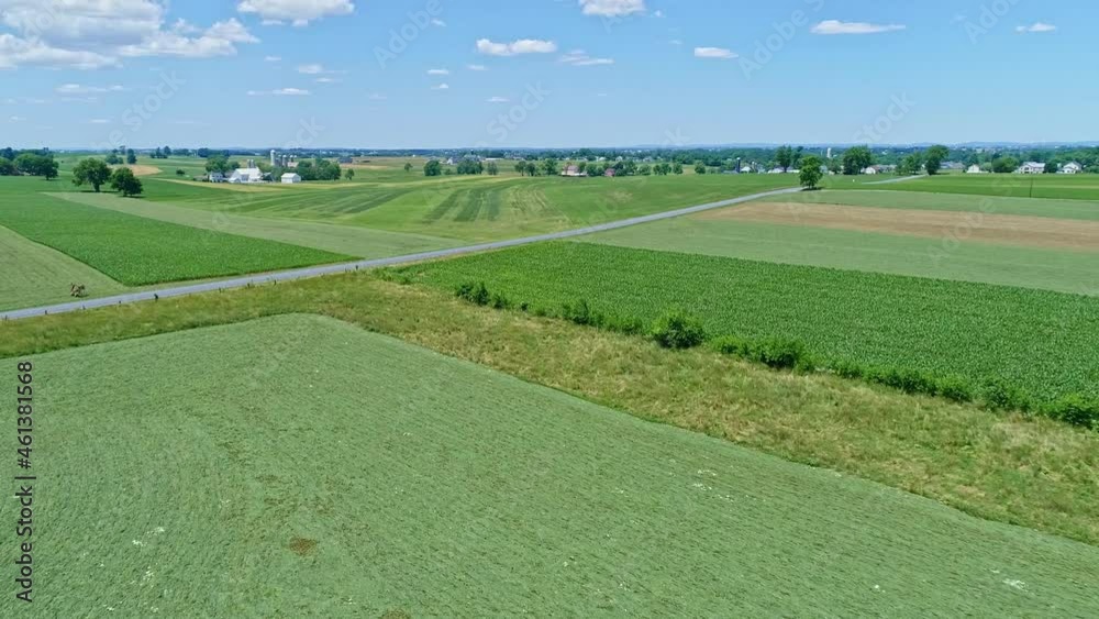 An Aerial View of the Farm Countryside with Planted Fields and Pastures on a Beautiful Sunny Day An Aerial View of the Farm Countryside with Planted Fields and Pastures on a Beautiful Sunny Day
