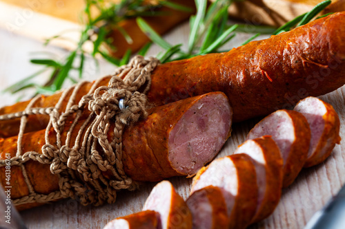 Lean smoked ham sausage on wooden table, popular czech meat product