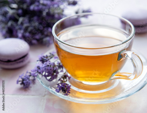 Cup of tea with macaroon dessert with lavender flavor
