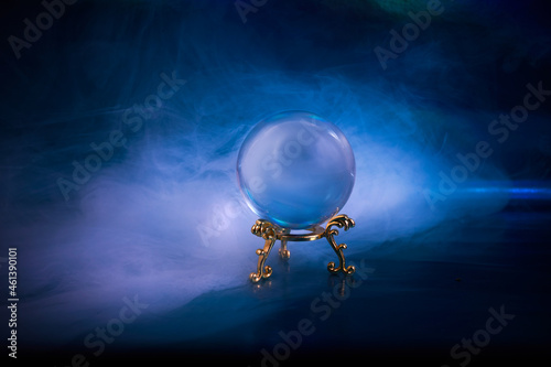 Crystal ball in a dark blue smoky background. Guessing for the future. photo
