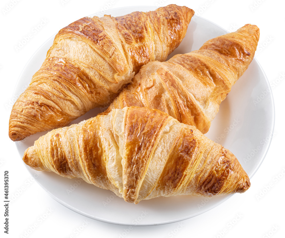 Tasty crusty croissants on the plate on white background. Top view. File contains clipping path.