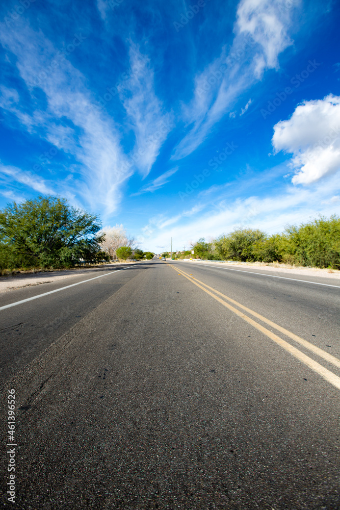 Asphalt road and blue sky with clouds