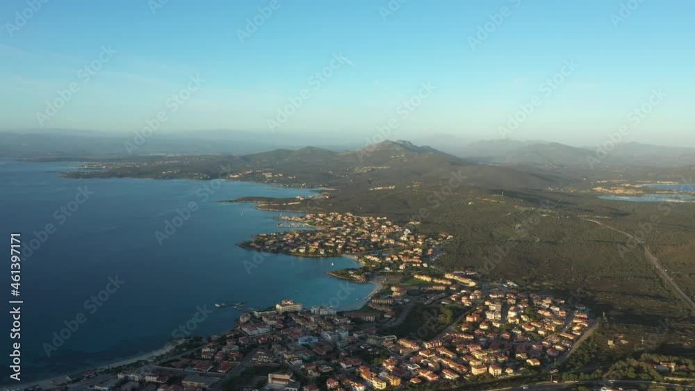 View from above, stunning aerial view of the city of Golfo Aranci during a beautiful sunrise. Golfo Aranci is a village that extends along a strip of land into turquoise sea. Sardinia, Italy. View from above, stunning aerial view of the city of Golfo Aranci during a beautiful sunrise. Golfo Aranci is a village that extends along a strip of land into turquoise sea. Sardinia, Italy.