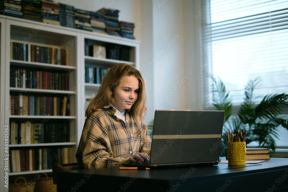 Teenage girl doing homework at a desk in her bedroom. teen girl school ...