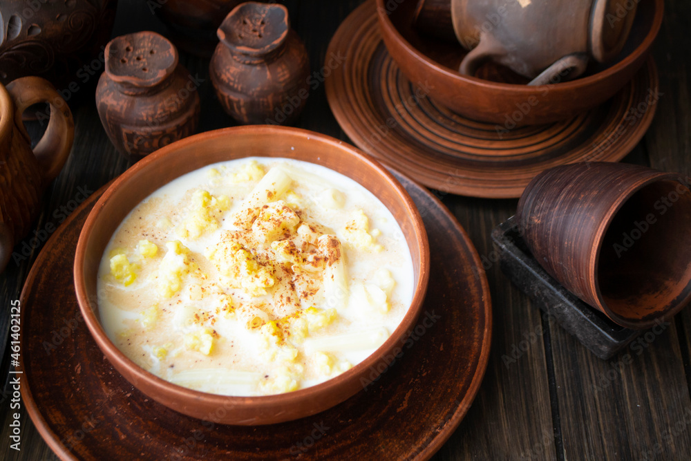 A serving of clam chowder in an old bowl, traditional milk soup of Belarus A serving of clam chowder in an old bowl, traditional milk soup of Belarus