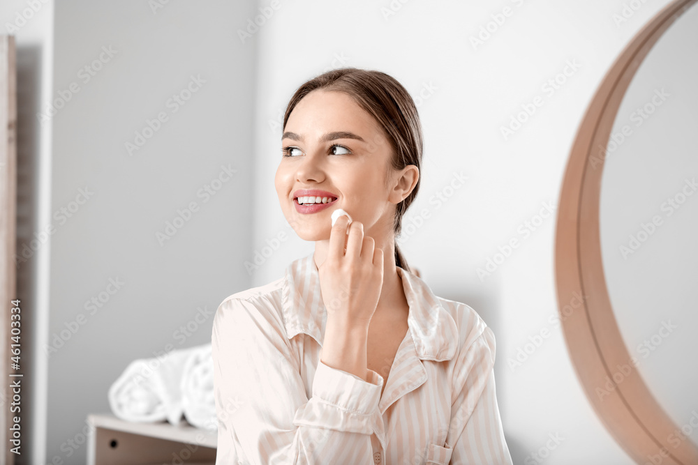 Beautiful young woman with cotton wool in bathroom Beautiful young woman with cotton wool in bathroom