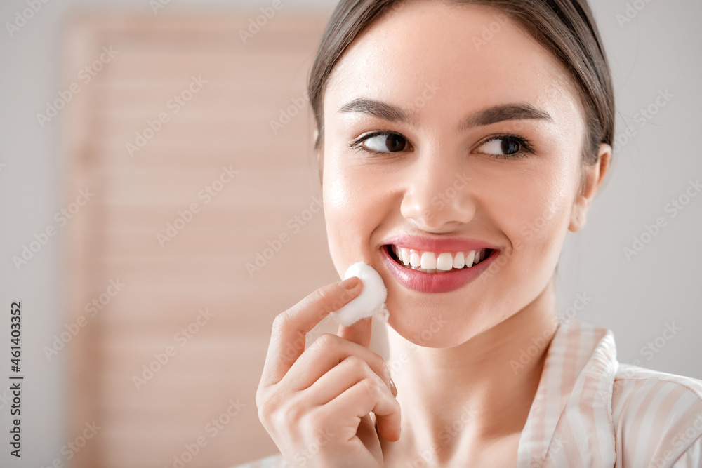 Beautiful young woman with cotton wool in bathroom Beautiful young woman with cotton wool in bathroom