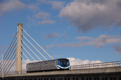Skytrain passing Cable stayed bridge in cloudy and blue sky in Vancouver photo