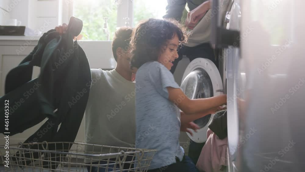 Slow motion of man doing laundry with sons