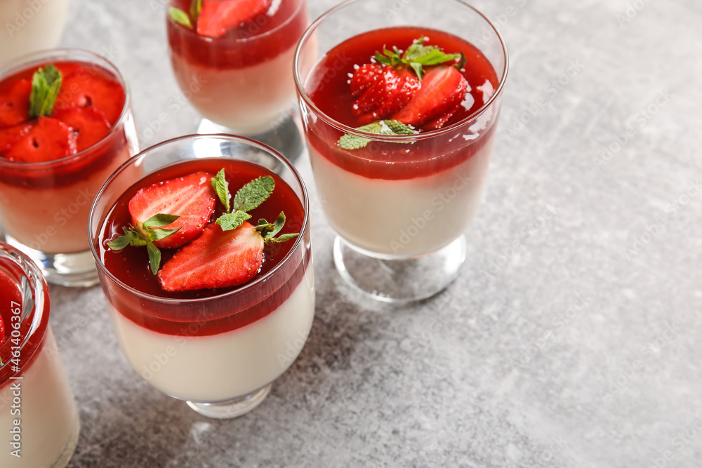 Glasses with delicious strawberry panna cotta and mint on light background Glasses with delicious strawberry panna cotta and mint on light background