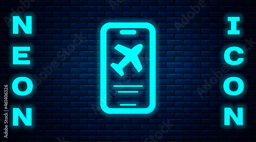 Glowing neon Smartphone with electronic boarding pass airline ticket icon isolated on brick wall background. Passenger plane mobile ticket for web and app. Vector