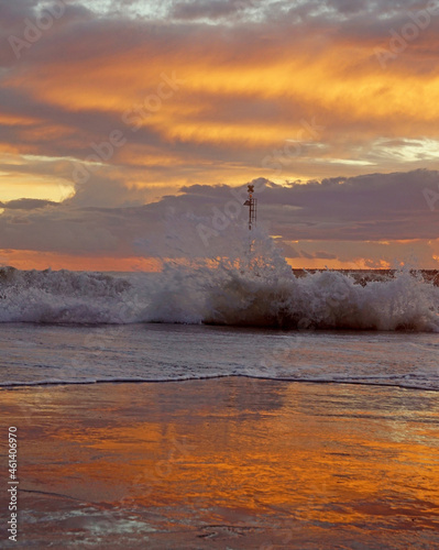 pier in the sunset with reflections at cinquale of montignoso near massa in north of tuscany