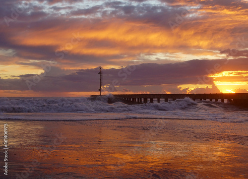 pier in the sunset with reflections at cinquale of montignoso near massa in north of tuscany
