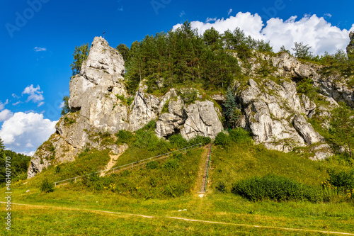 Zabi Kon and Mnich rock with path to Holy Mary cave shrine in Kobylanska Valley within Jura Krakowsko-Czestochowska upland near Cracow in Lesser Poland photo