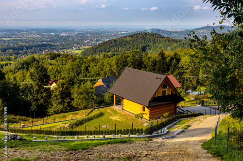 Fototapeta Naklejka Na Ścianę i Meble -  Panoramic view of northern slope of Little Beskids in Beskidy Mountains with wooden village house Targanice village near Andrychow in Lesser Poland