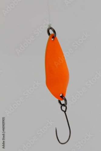orange fishing lure on a strong fishing line