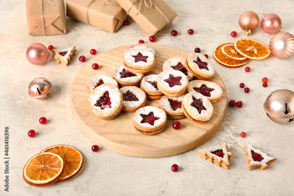 Board with tasty Linzer cookies and Christmas decor on grunge background Board with tasty Linzer cookies and Christmas decor on grunge background