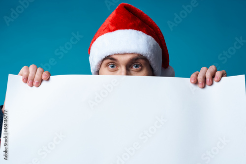 Cheerful man in a santa hat holding a banner holiday isolated background