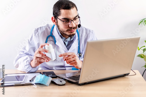 Man doctor holding bottle of pills.