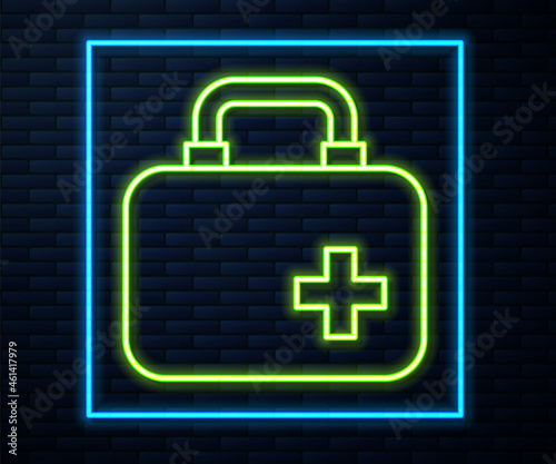 Glowing neon line First aid kit icon isolated on brick wall background. Medical box with cross. Medical equipment for emergency. Healthcare concept. Vector