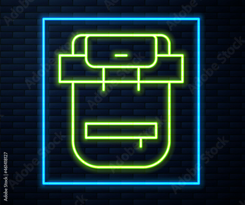 Glowing neon line Hiking backpack icon isolated on brick wall background. Camping and mountain exploring backpack. Vector