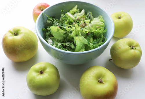 fresh salad leaves with pumpkin seeds in a plate, close-up and green apples. Comfortable digestion, proper nutrition, weight loss. The texture of vegetables, salad. Seasonal vitamins, fiber