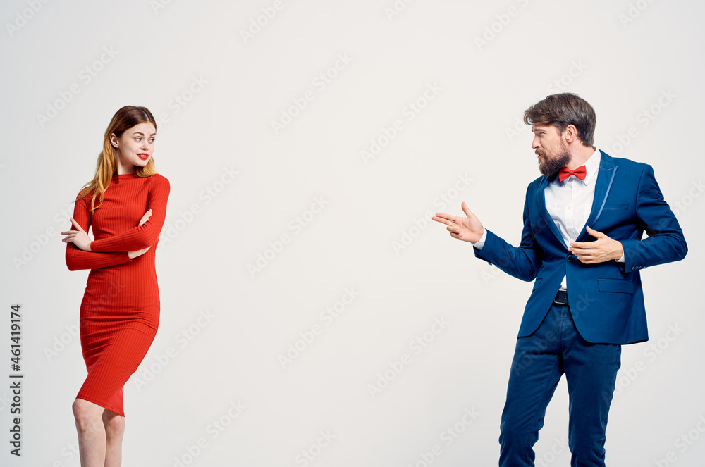a man in a suit next to a woman in a red dress communication fashion isolated background a man in a suit next to a woman in a red dress communication fashion isolated background