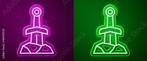 Glowing neon line Sword in the stone icon isolated on purple and green background. Excalibur the sword in the stone from the Arthurian legends. Vector