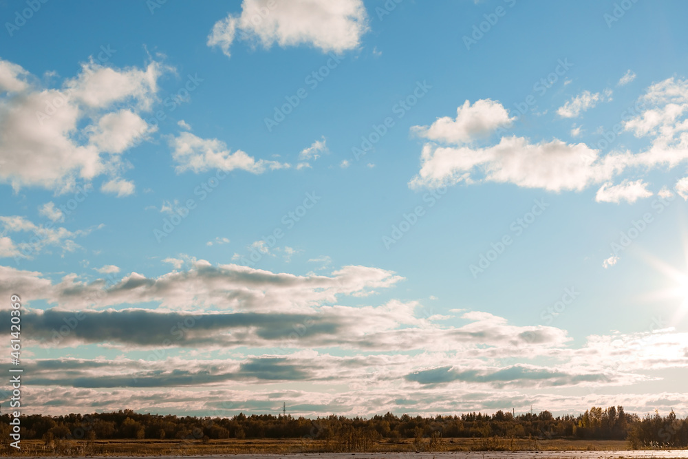 Autumn landscape on the runway for small aircraft and the sky with fluffy clouds in the golden hour of autumn.