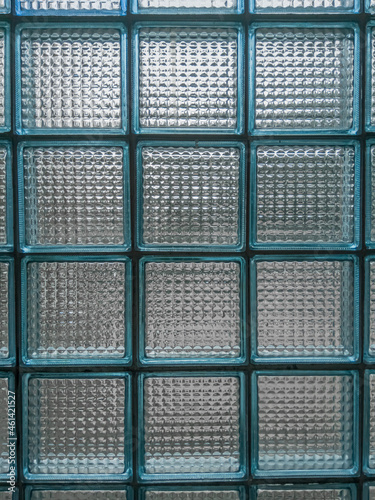The wall is lined with blue glass blocks, textured.