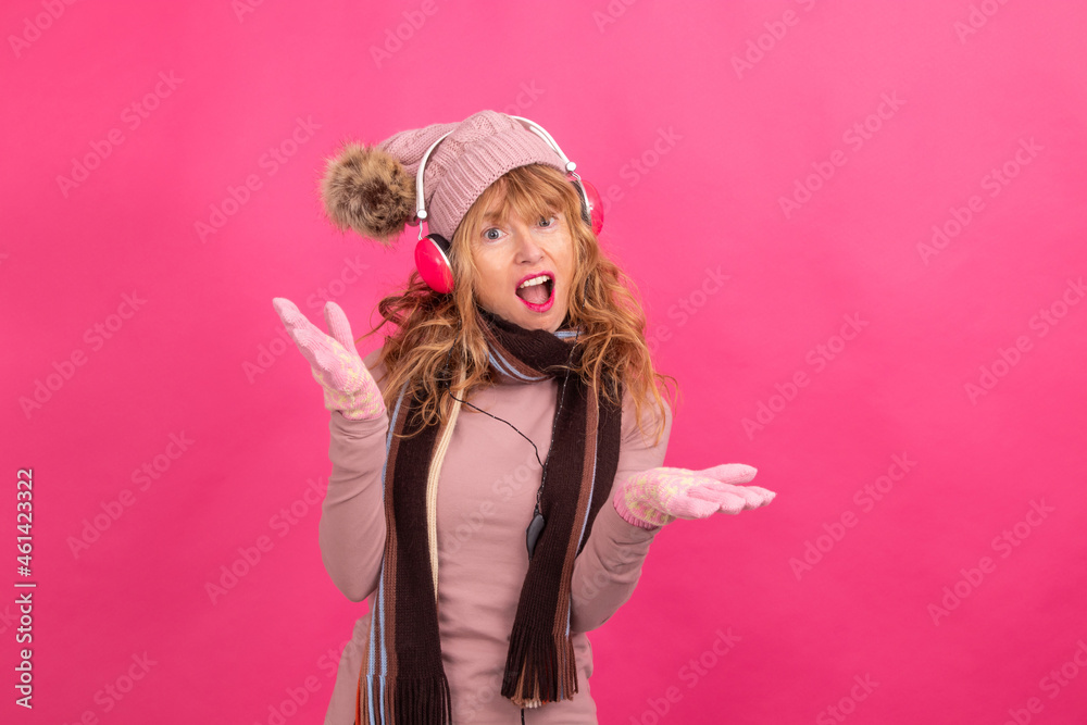 adult woman with headphones and warm or winter clothes dancing isolated adult woman with headphones and warm or winter clothes dancing isolated