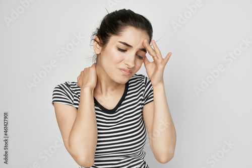 sick woman holding his head migraine depression light background