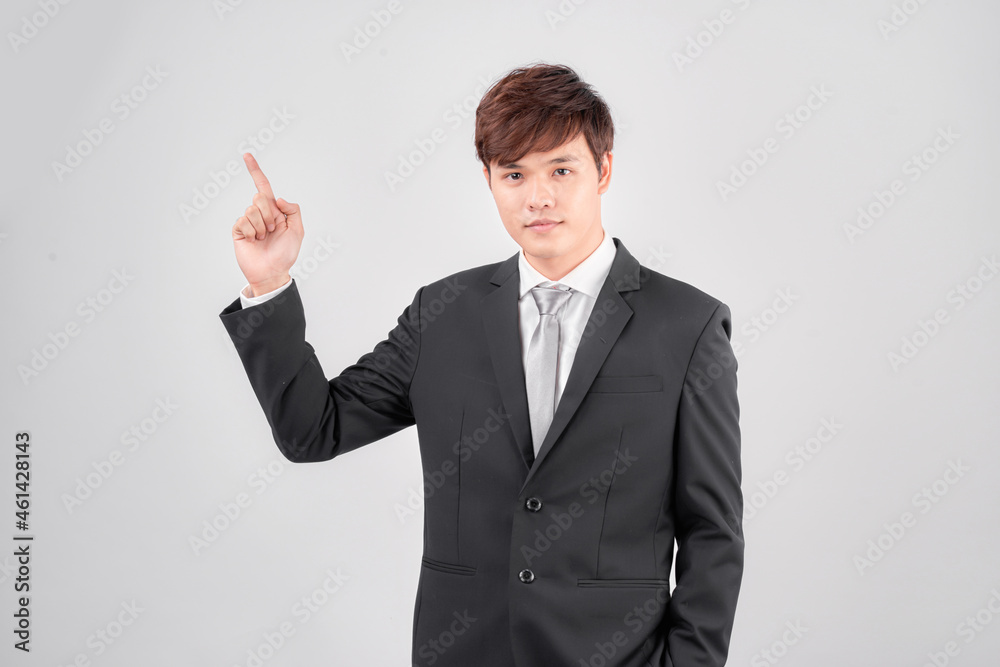 Young asian business man against a white background isolated smiling cheerfully pointing with forefinger away. Young asian business man against a white background isolated smiling cheerfully pointing with forefinger away.