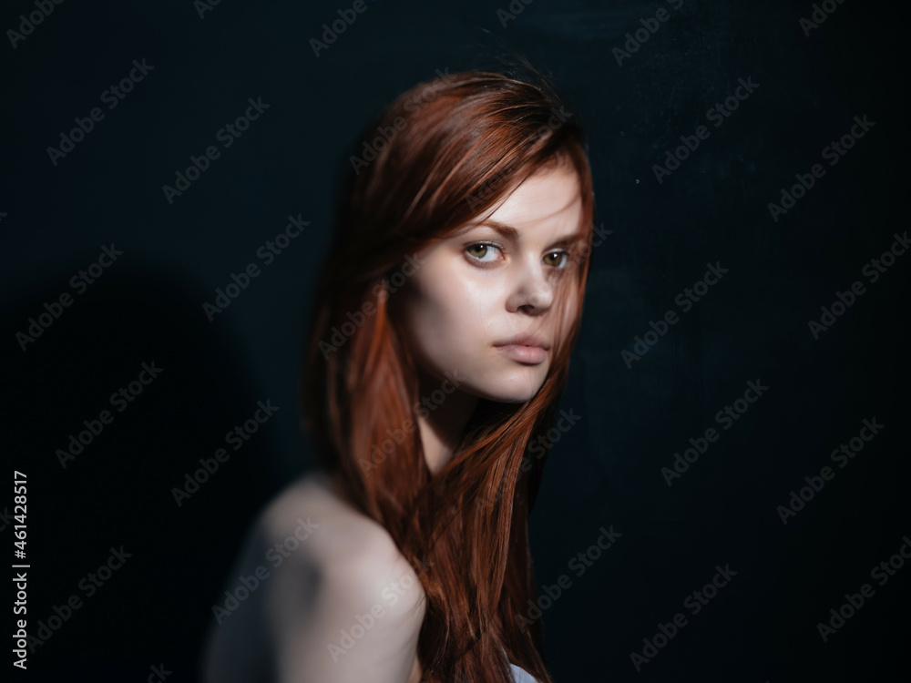 woman with bare shoulders red hair posing isolated background